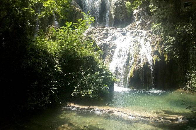 Private Day Trip to Krushuna Waterfalls and Devetashka Cave - Devetashka Cave: A Well-Lit Walk with Green on the Floor